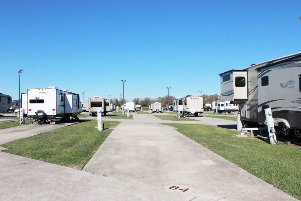 Image of a pull-thru RV space with concrete pad at Port Arthur RV Resort